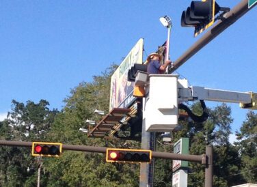 closeup of crew member working on traffic light