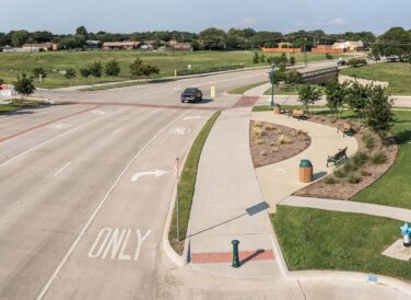 road by grassy fields and trail by North Colony Boulevard